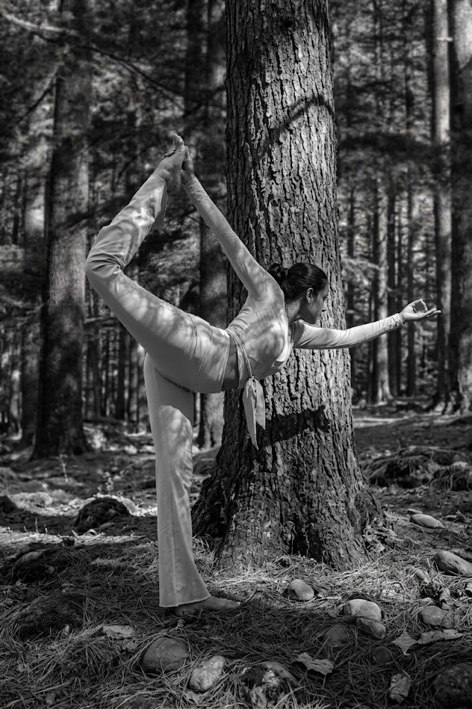 Yashashree Kale in a standing yoga pose in the forest