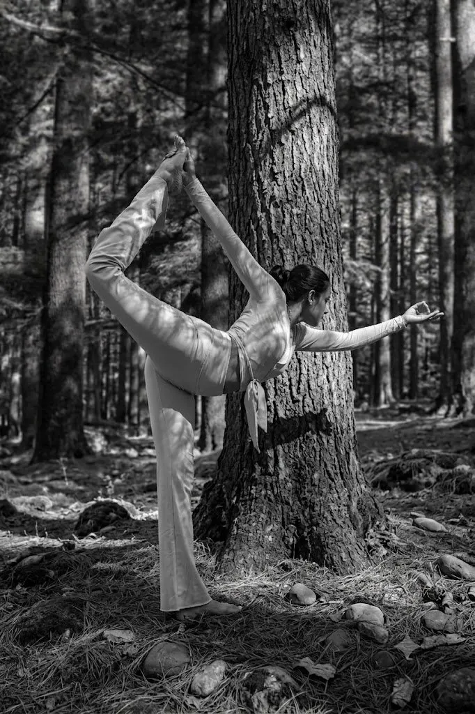 Yashashree Kale in a standing yoga pose in the forest