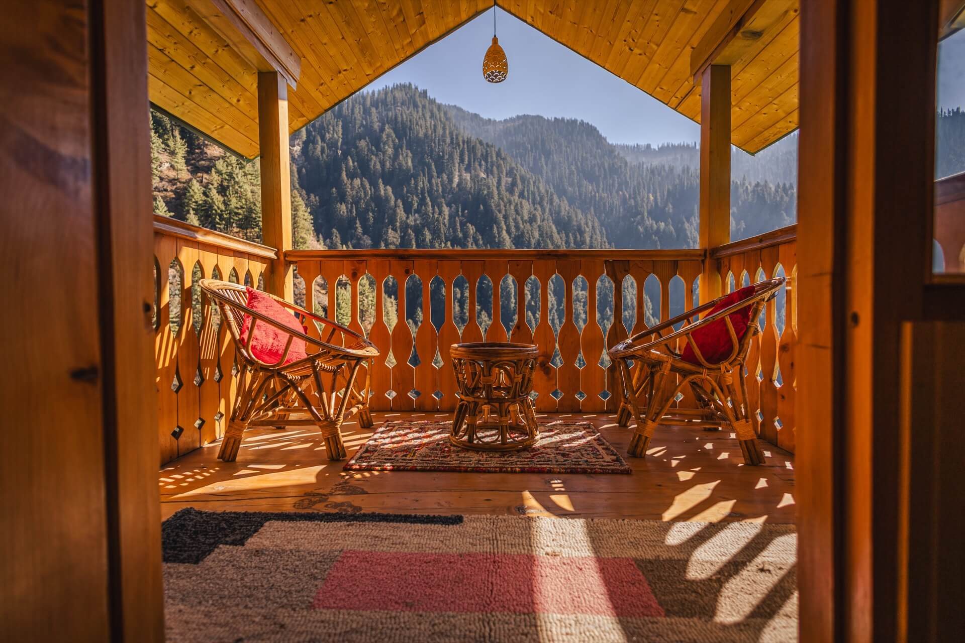 A balcony over the valley at Wild, with cane chairs and a low table