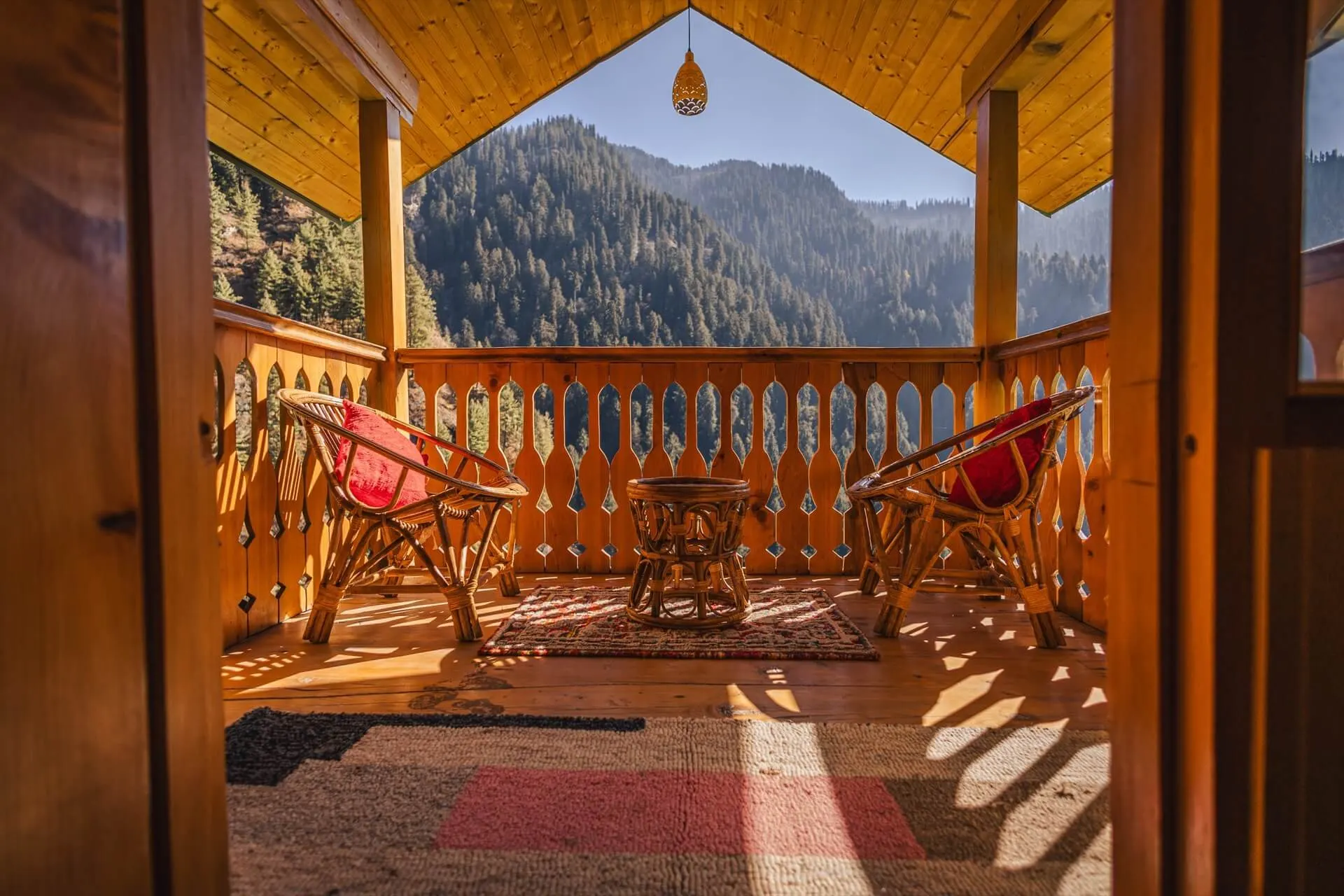 Morning light on the balcony at Wild, with chairs facing the forest