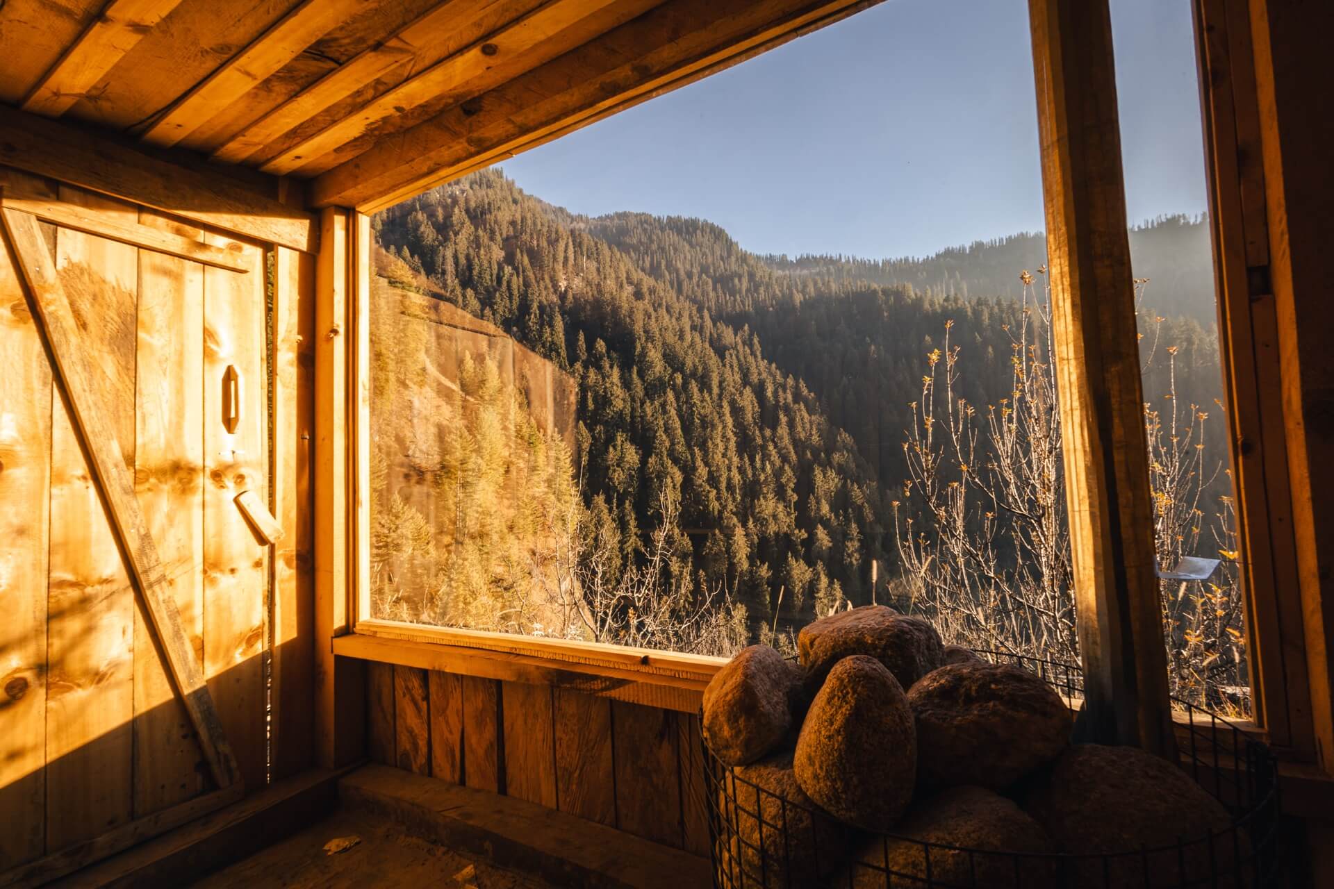 Cedar wood-fired sauna at Wild with a window onto the forested valley