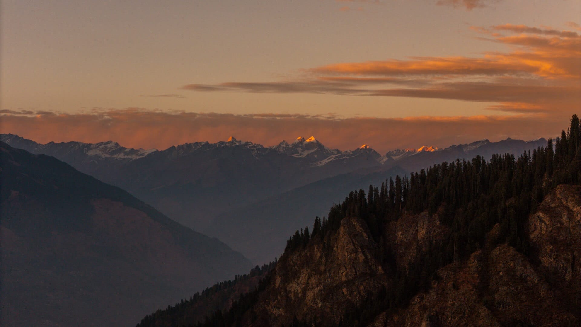 Snow-capped Himalayan peaks glowing at sunset, seen from Wild